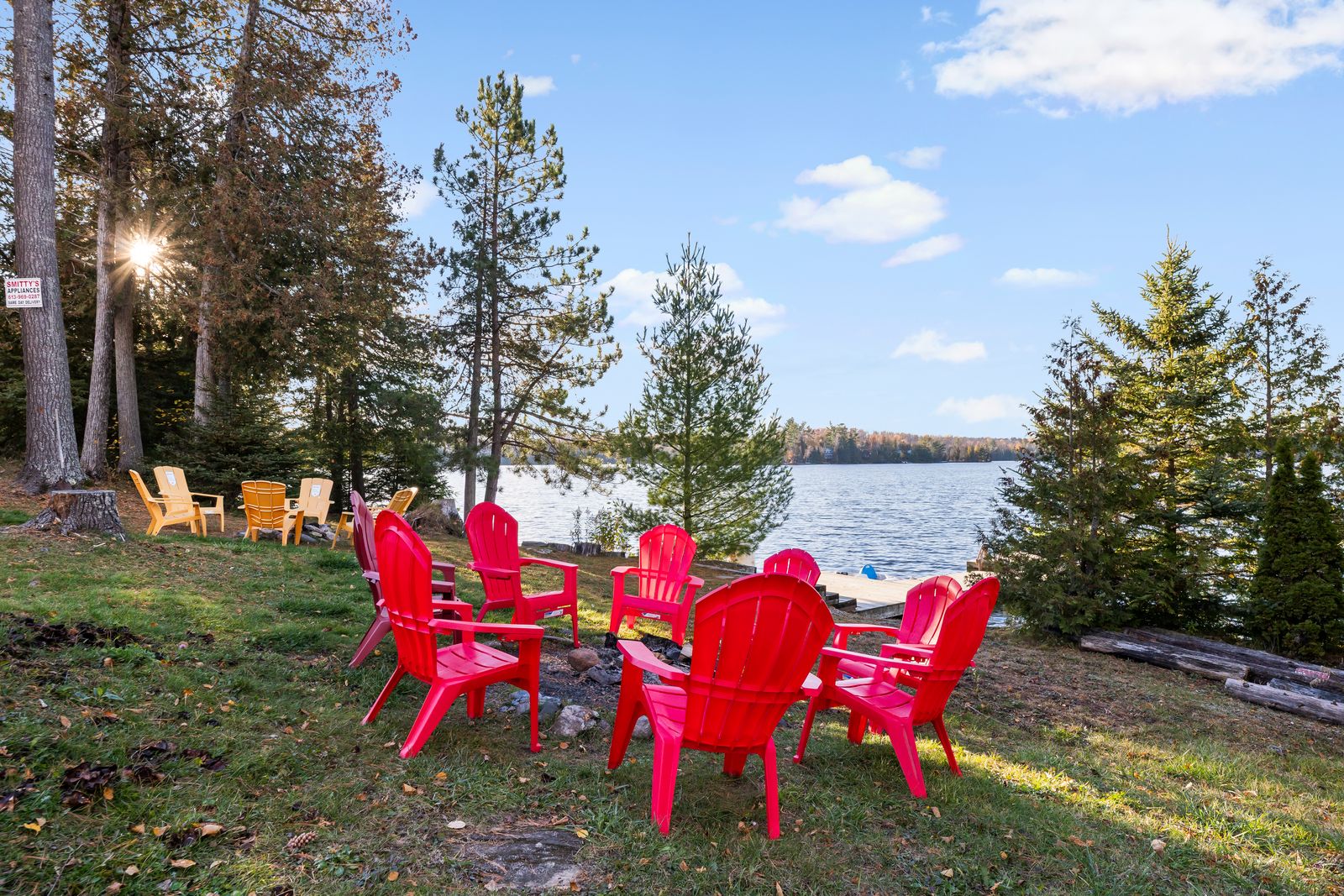 Lakeside fire pit with red Adirondack chairs overlooking Gunter Lake at 372 Gunter Lake Rd, Tudor and Cashel